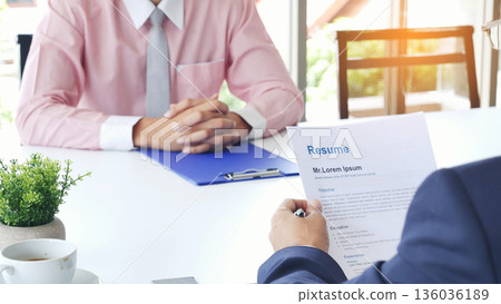 Businessman job interview by human resource HR officer interviwing, talk new employee shaking hands in office with smiling face. HR Manager interview check resume, face to face. Job Interview Concept 136036189