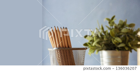 Banner Plant pot sharp pencil vase office supply decor on wood table. Green decorate home office desk. Green plant vase on wood office desk sharpen pencil box office decorate table with copy space Banner Plant pot sharp pencil vase office supply decor on wood table. Green decorate home office desk. Green plant vase on wood office desk sharpen pencil box office decorate table with copy space 136036207