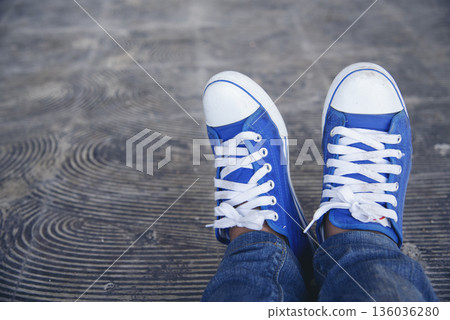 Sport sneakers footwear young woman knelt down do up shoelaces. Ready running shoes in sport exercise jogging person. Close up hands tie up runner shoelaces in fitness gym healthy person lifestyle. Sport sneakers footwear young woman knelt down do up shoelaces. Ready running shoes in sport exercise jogging person. Close up hands tie up runner shoelaces in fitness gym healthy person lifestyle. 136036280