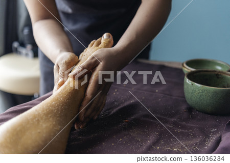 Massage Thai Spa foot massage. Close up woman leg side therapy relax treatment in spa salon. Spa body foot pain massage. Woman happy relax skin lying spa bed oil wellness body skincare therapist Massage Thai Spa foot massage. Close up woman leg side therapy relax treatment in spa salon. Spa body foot pain massage. Woman happy relax skin lying spa bed oil wellness body skincare therapist 136036284