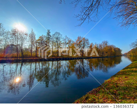 Rijkevorsel, Antwerpse Kempen, Belgium, Peaceful waterway reflecting vibrant fall foliage beneath 136036372