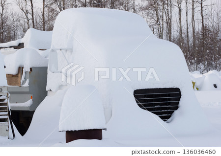 Old abandoned dump truck covered with high snow. Old abandoned dump truck covered with high snow. 136036460