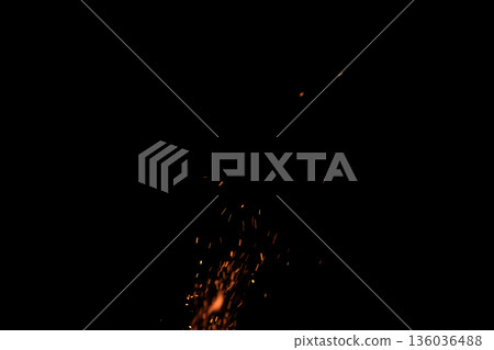 Sparks from campfire over dark background in the night 136036488
