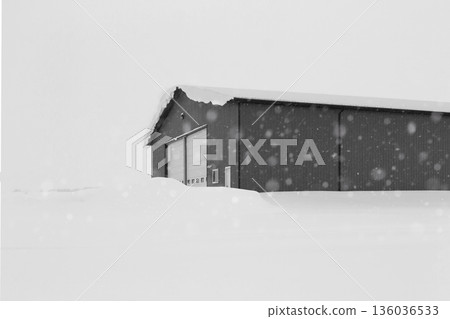 Industrial storage building covered with snow after snowfall. Industrial storage building covered with snow after snowfall. 136036533