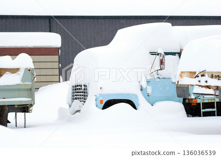 Old abandoned dump truck covered with high snow. Old abandoned dump truck covered with high snow. 136036539