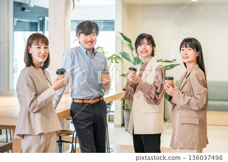 Businessman and businesswoman chatting over coffee in the office 136037498