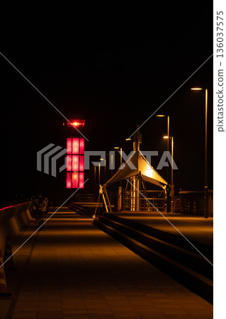 Lighthouse and pier at night Lighthouse and pier at night 136037575