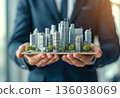 Business professional holds a detailed architectural model of a modern city skyline during a business presentation 136038069