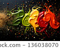 Vibrant colors of spices and sauces arranged artistically on a dark surface showcase culinary creativity and passion 136038070