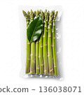 Fresh green asparagus bundle packed for cooking or meal prep with a bay leaf on top in a clear packaging 136038071