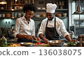 Chefs preparing fresh ingredients together in a cozy kitchen setting during a culinary class 136038075