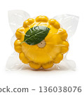 Fresh yellow squash packaged with a green leaf ready for sale in a grocery store 136038076