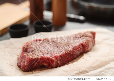 closeup raw seasoned new york steak on concrete countertop background closeup raw seasoned new york steak on concrete countertop background 136038509