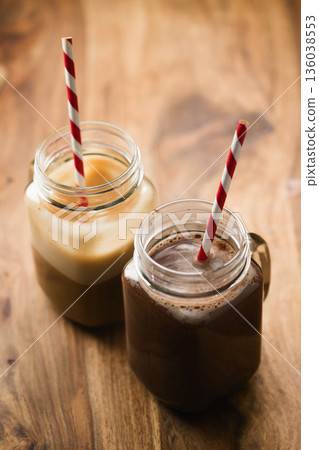 warm cocoa and coffee in jar mugs on a wooden table warm cocoa and coffee in jar mugs on a wooden table 136038553