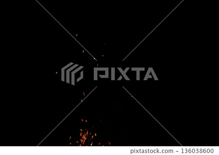 Sparks from campfire over dark background in the night 136038600