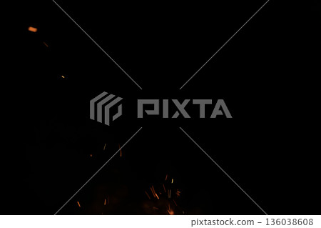 Sparks from campfire over dark background in the night Sparks from campfire over dark background in the night 136038608