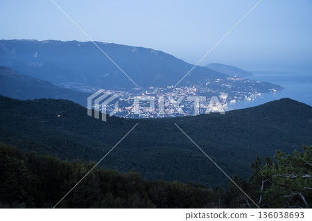 Evening seaside calmness, Serene coastal sunset landscape, Peaceful harbor illuminated at twilight amidst rolling green slopes Evening seaside calmness, Serene coastal sunset landscape, Peaceful harbor illuminated at twilight amidst rolling green slopes 136038693