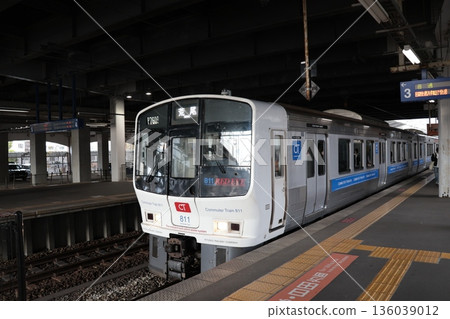 A Kagoshima Main Line train stopping at the platform at JR Kurume Station A Kagoshima Main Line train stopping at the platform at JR Kurume Station 136039012