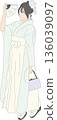 A woman wearing hakama and holding a fan 136039097