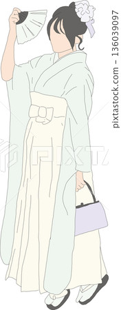 A woman wearing hakama and holding a fan A woman wearing hakama and holding a fan 136039097