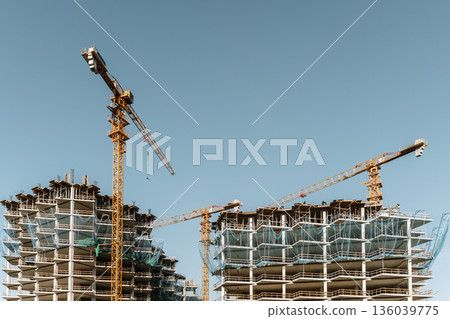 Construction of a building. Construction site with crane. Business, development, industry. 136039775