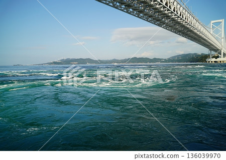 Akashi Kaikyo Bridge and whirlpools seen from a sightseeing boat Akashi Kaikyo Bridge and whirlpools seen from a sightseeing boat 136039970