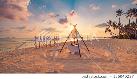 Romantic tropical beach sunset marry me proposal table with candles palm trees ocean view luxury paradise background Romantic tropical beach sunset marry me proposal table with candles palm trees ocean view luxury paradise background 136040287
