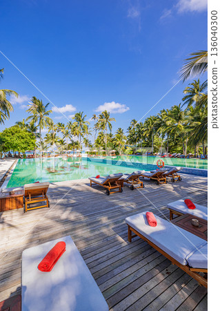 Vertical panoramic luxury infinity pool beach resort with palm trees sun loungers turquoise ocean horizon tropical summer paradise 136040300