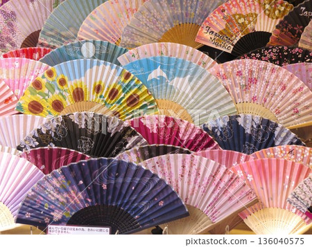 商店裡擺放著一排色彩繽紛的扇子。 商店裡擺放著一排色彩繽紛的扇子。 136040575