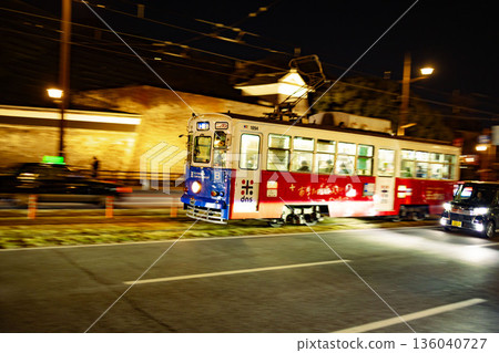 A tram running through the night in front of Kumamoto Castle A tram running through the night in front of Kumamoto Castle 136040727