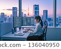 System development work in an office at dusk overlooking Tokyo Tower 136040950