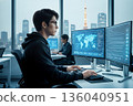 A global work scene of an IT engineer with a world map displayed on a monitor 136040951
