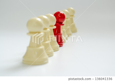 Red pawn stood out from the rest of the pawns representing courage to speak up concept. 136041336