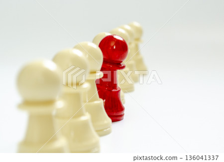 Standing red pawn breaking formation representing speaking up. Standing red pawn breaking formation representing speaking up. 136041337