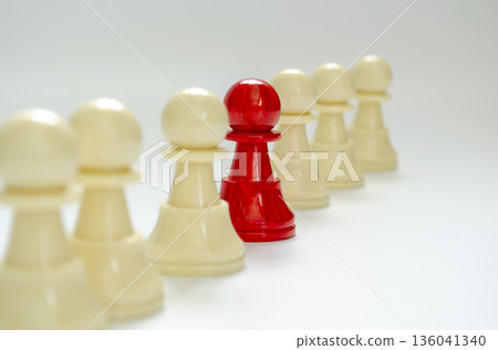 Standing red pawn confronting white pawns representing leadership voice. Standing red pawn confronting white pawns representing leadership voice. 136041340