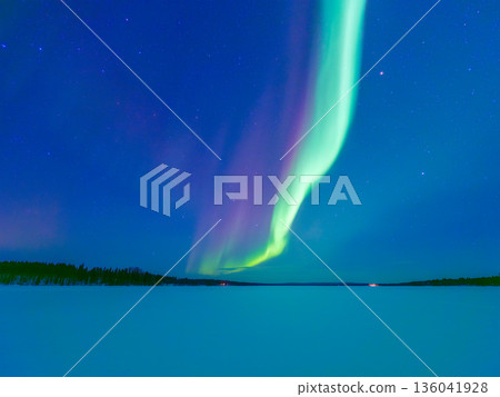 The green northern lights reflect on the ice in Norway, Finland, and Sweden. 136041928