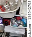 Disorganized kitchen drawers and cluttered storage containers 136042798