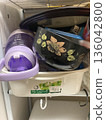 Disorganized kitchen storage drawers and overstuffed storage containers 136042800