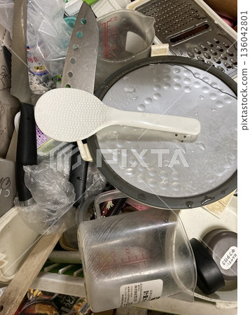 Disorganized kitchen and scattered cooking utensils Disorganized kitchen and scattered cooking utensils 136042801