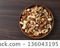 Mixed nuts in a wooden bowl Mixed nuts in a wooden bowl 136043195
