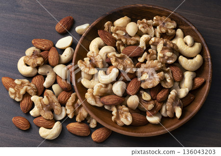 Mixed nuts in a wooden bowl Mixed nuts in a wooden bowl 136043203