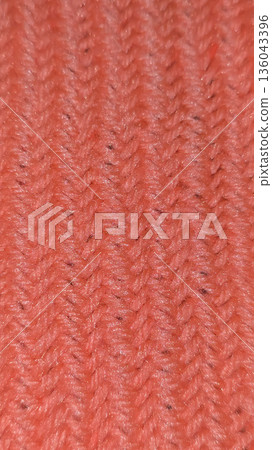 Orange knit fabric texture, suitable for home decor, fashion, or textile crafts. Orange knit fabric texture, suitable for home decor, fashion, or textile crafts. 136043396