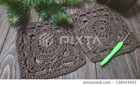A crochet pattern of brown squares, perfect for home decor and fashion. Pattern. A crochet pattern of brown squares, perfect for home decor and fashion. Pattern. 136043401