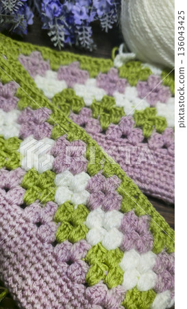 A colorful knitted fabric texture suitable for home decor, fashion, or textile 136043425