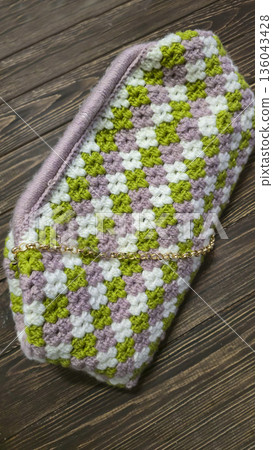 A colorful knitted fabric texture suitable for home decor, fashion, or textile 136043428