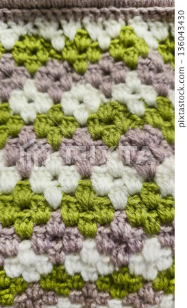 A colorful knitted fabric texture suitable for home decor, fashion, or textile 136043430