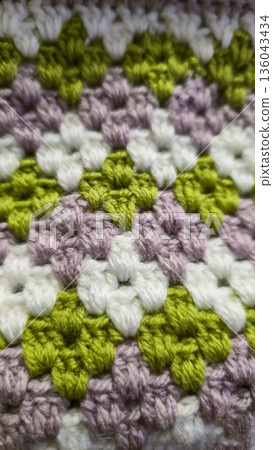 A colorful knitted fabric texture suitable for home decor, fashion, or textile 136043434