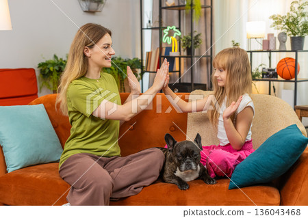 Mother daughter clap hands laugh and play hand game together joyful family bonding with warm rhythm Mother daughter clap hands laugh and play hand game together joyful family bonding with warm rhythm 136043468