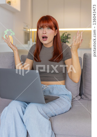 Young woman frustrated at laptop app crash virus glitch error freezes work causes despair and stress 136043473