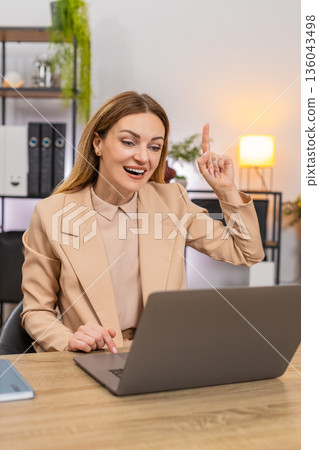 Businesswoman finds idea for presentation eureka moment smiles and working on deck slides quick plan Businesswoman finds idea for presentation eureka moment smiles and working on deck slides quick plan 136043498